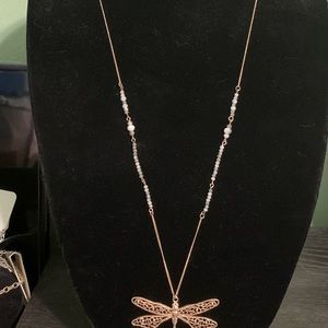 Gold dragonfly pendant necklace with beaded accent chain.